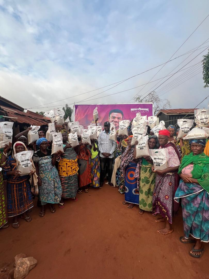 Women holding food support bags during a community outreach