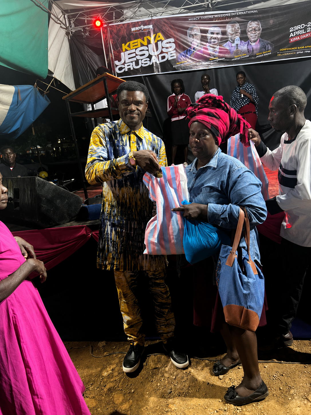 A local partner giving support to a woman during an outreach gathering